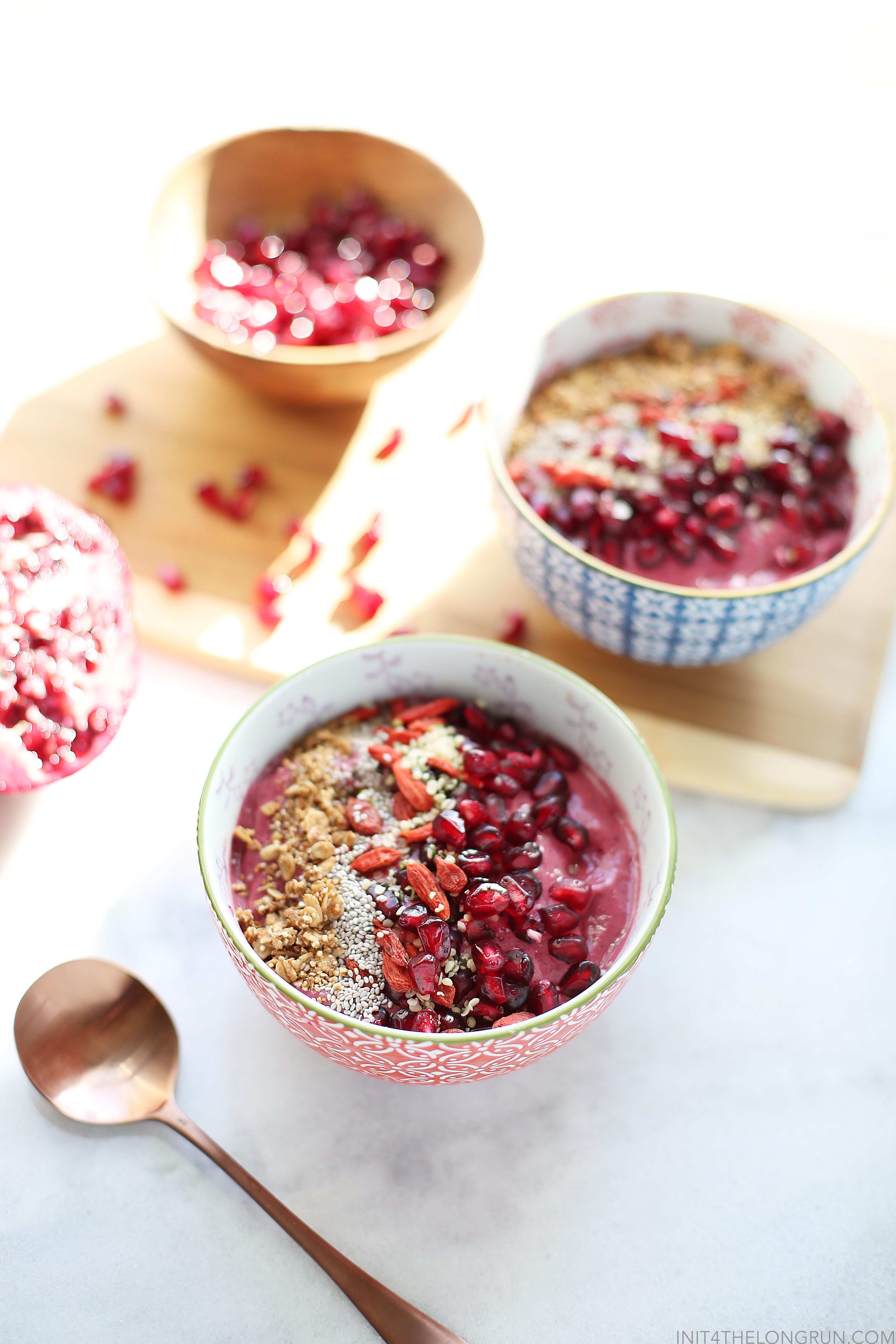 Cherry Pomegranate Smoothie Bowl // Celebrate seasonal pomegranates with this bright and bursting cherry pomegranate smoothie bowl topped with superfoods like chia and goji berries. Plus enjoy 5 other incredible smoothie bowl recipes from my favorite blogging bunch.